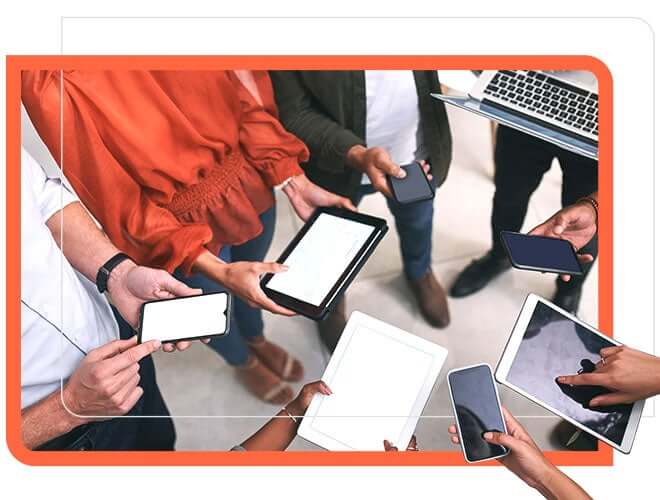 Group of employees using mobiles, tablets, and laptops.