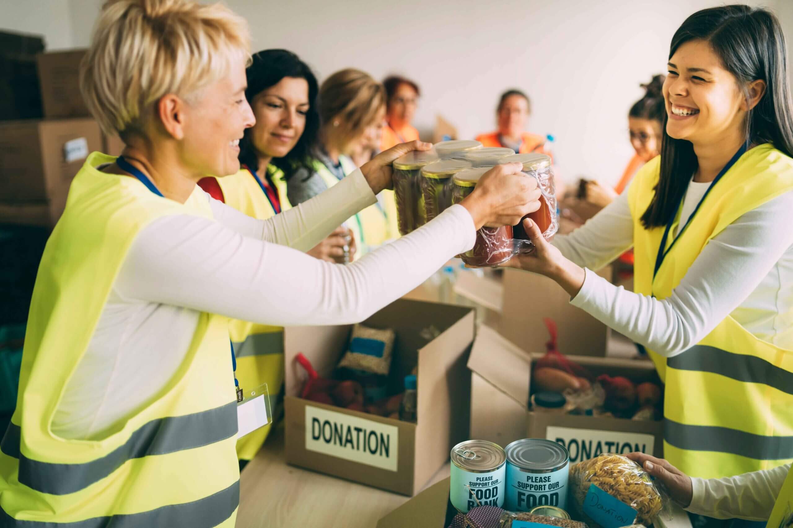 Corporates donating foods to people in a camp.