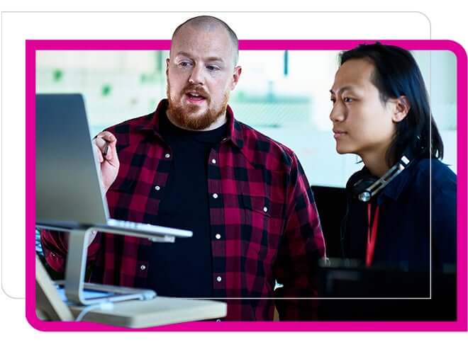 two men at computer discussing on screen info