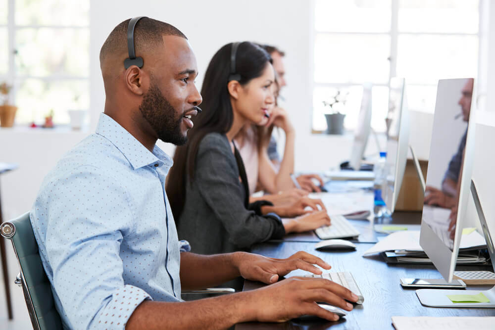 Group of service desk workers on calls