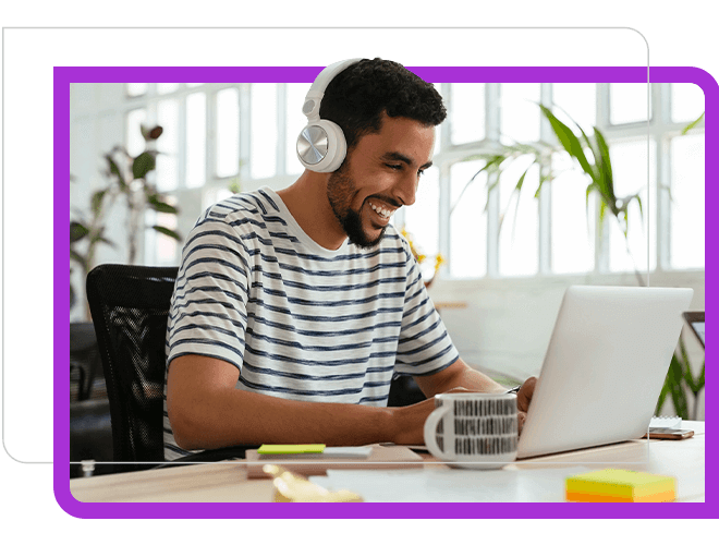 An Engineer wearing headphone is talking to team member in laptop.