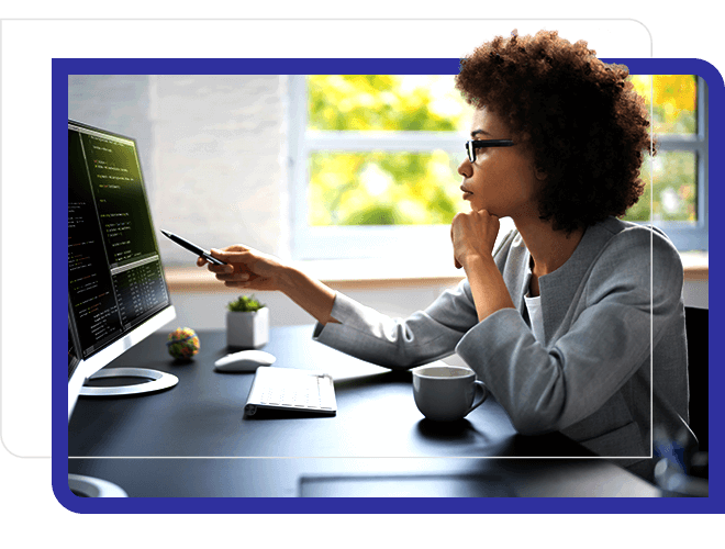 Business woman at work, analyzing multiple screens.