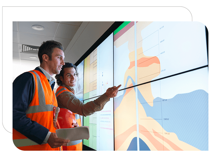 Two male oil gas engineers looking a terrain map.