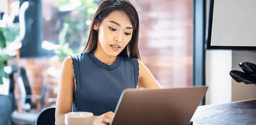 Asian woman looking at Laptop